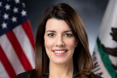 A portrait of a woman in front of US flag