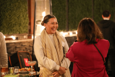 Two women speak to each other at an event