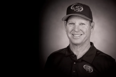 a black and white photo of Coach Reed Peters