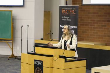 A professor speaks at a podium