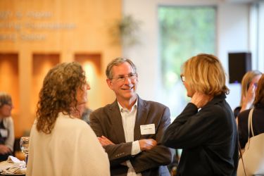 Attendees speaking with each other.