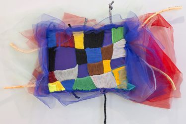 Colorful embroidered rectangle with tulle fluffs on the side