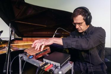 Composer Kyle Bruckmann working with electronic music equipment