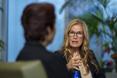 Moderator asking a speaker questions.