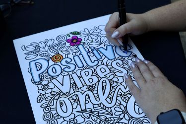 A person coloring. 