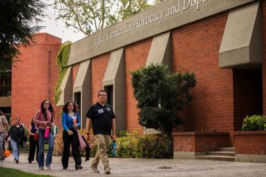 Students walk to class in front of McGeorge School of Law Egler Center of Advocacy building. 