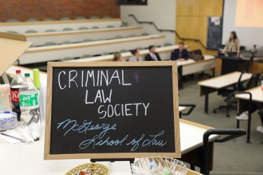 A chalkboard sign that says "Criminal Law Society"