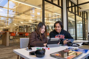 two students studying in library 