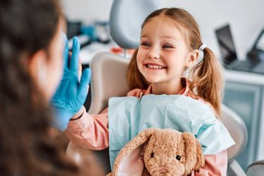 child smiling at dentist