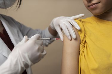 girl receiving vaccine in upper arm
