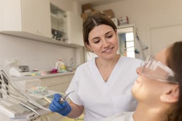 Woman dentist with a patient