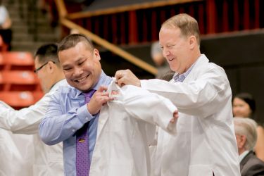 PharmD student with faculty member at White Coat Ceremony
