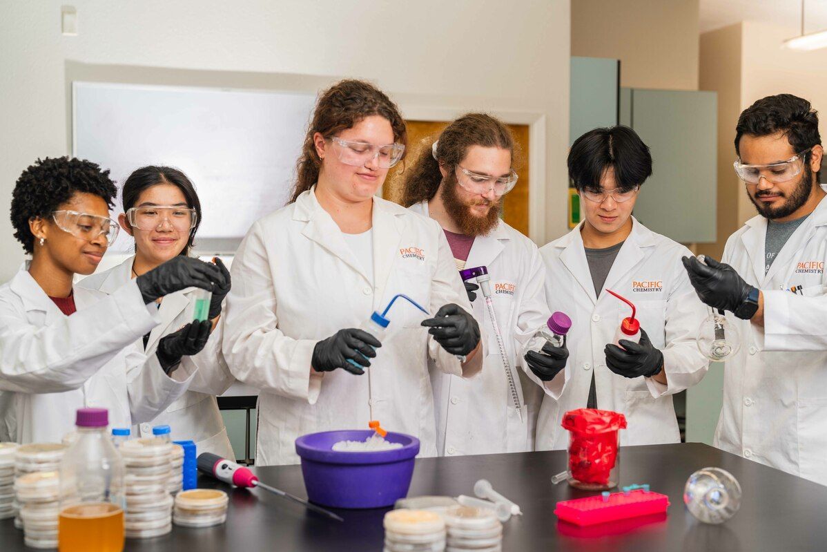 students in a lab holding bottles