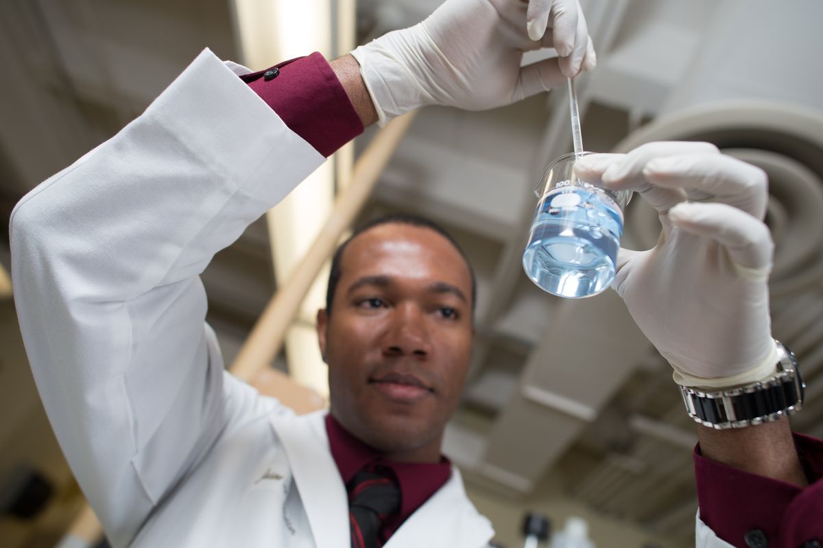 Pharmacy student examining something in a test tube