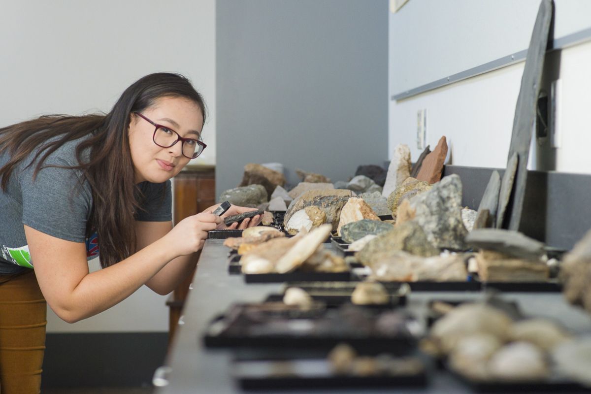 Student studying rocks in classroom