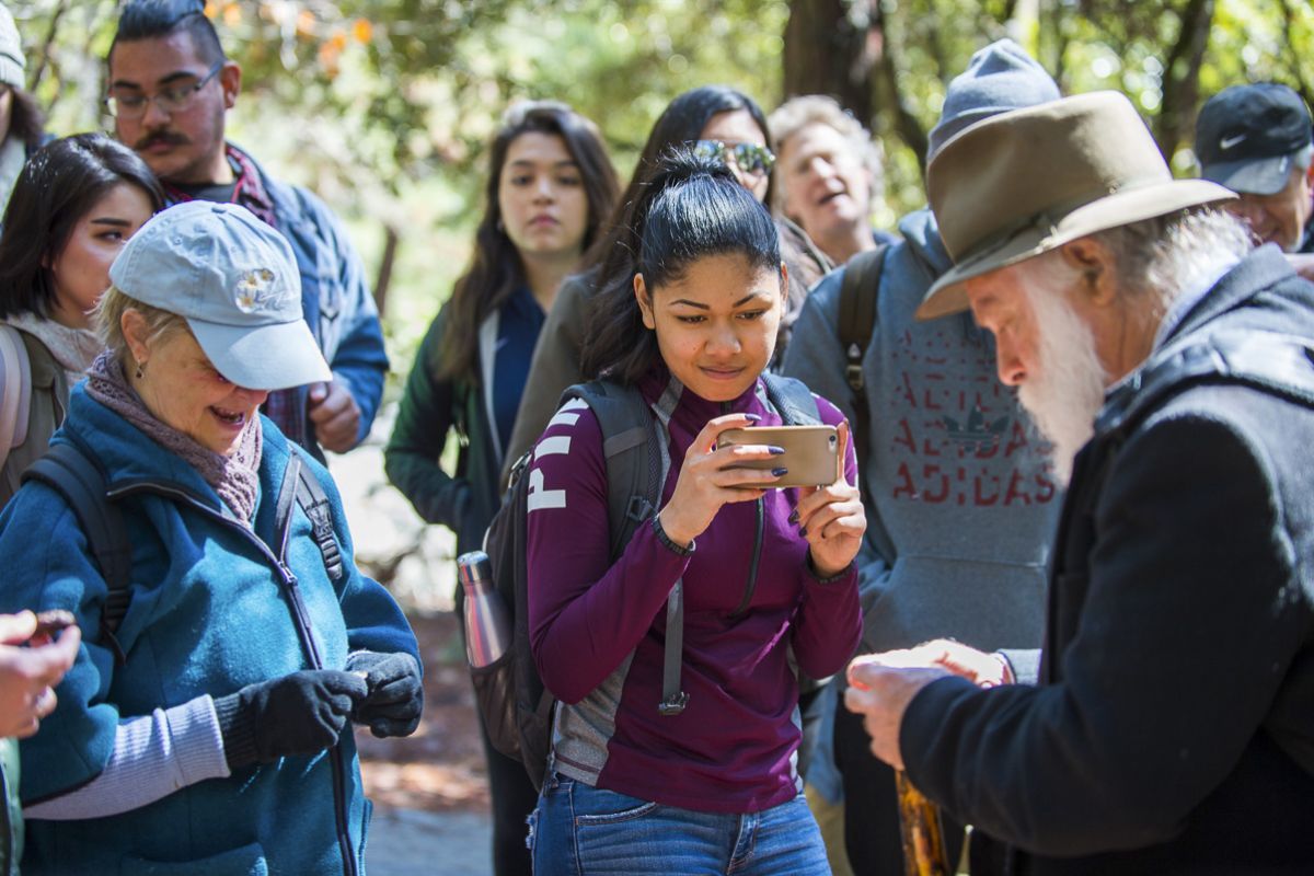 student taking picture of tour guide