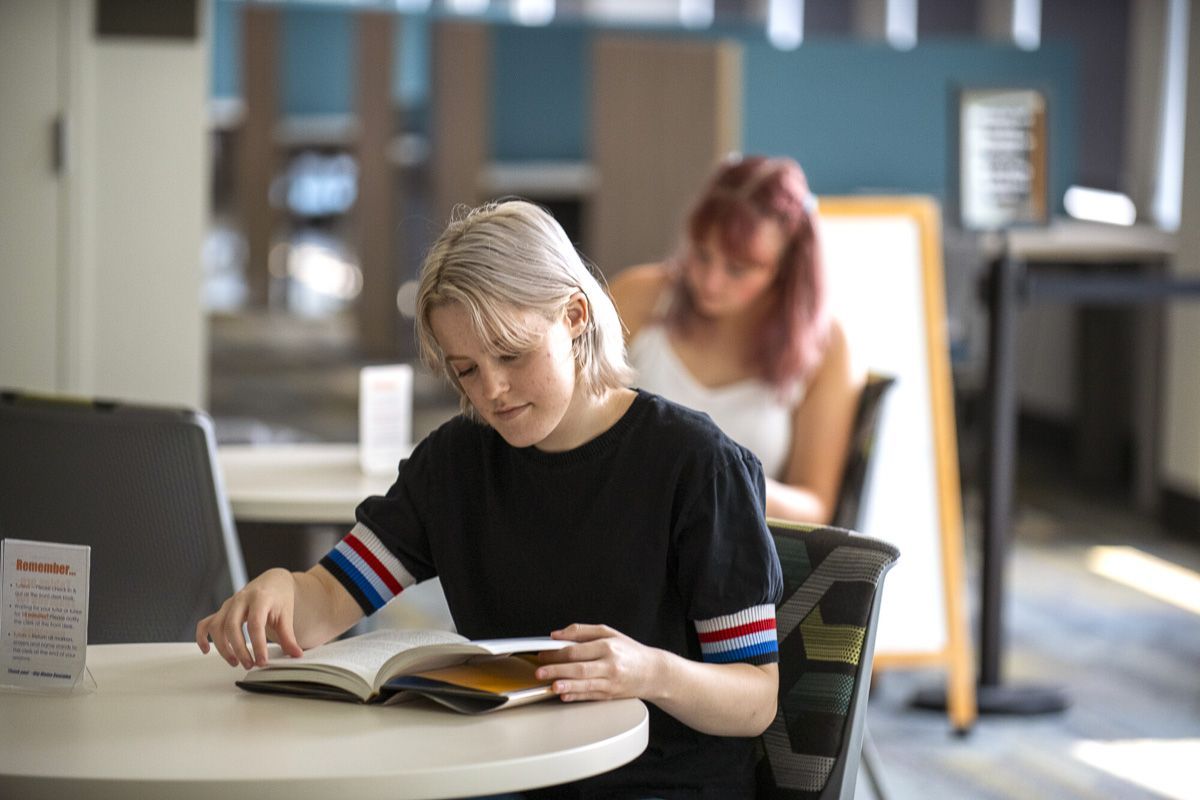 Student reading in the Academic Commons