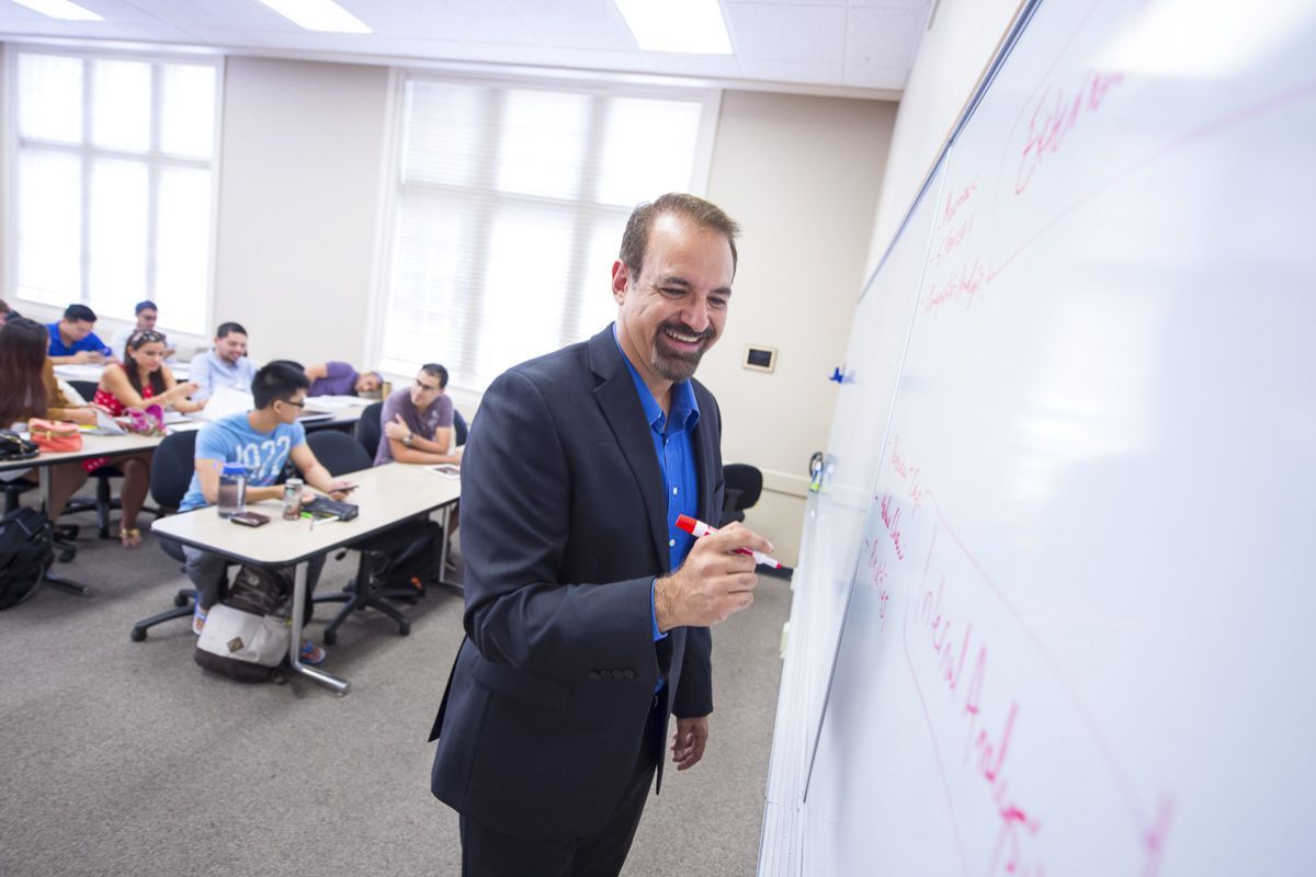 Eberhardt School of Business professor at white board in classroom