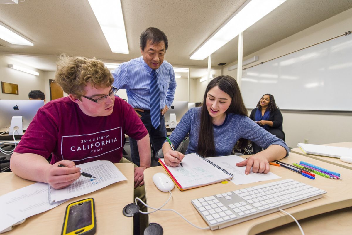 College of the Pacific communications classroom with faculty working with students