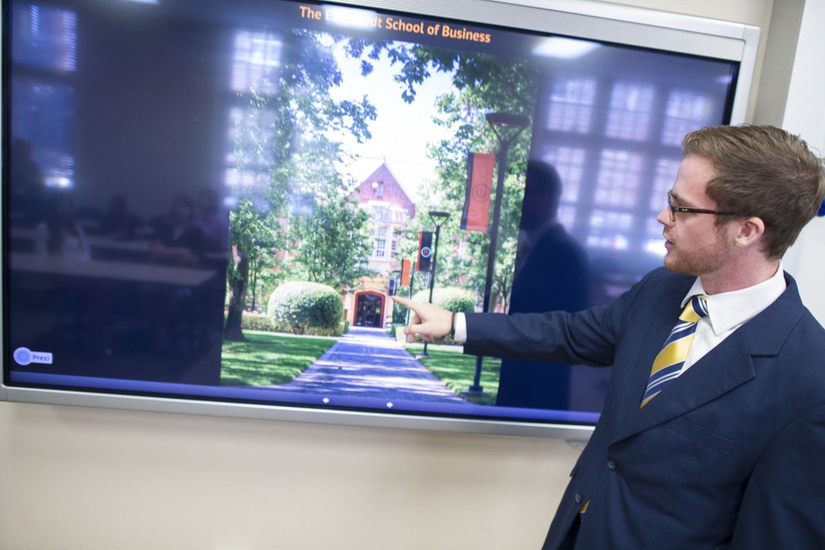 MBA student presenting on a large screen
