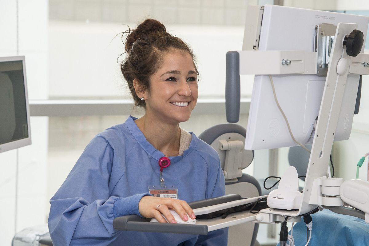 medical assistant entering records on computer