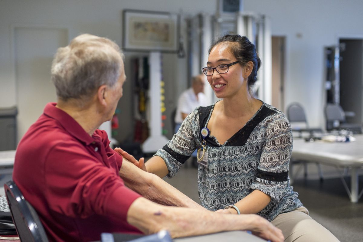 student working with patient in clinic
