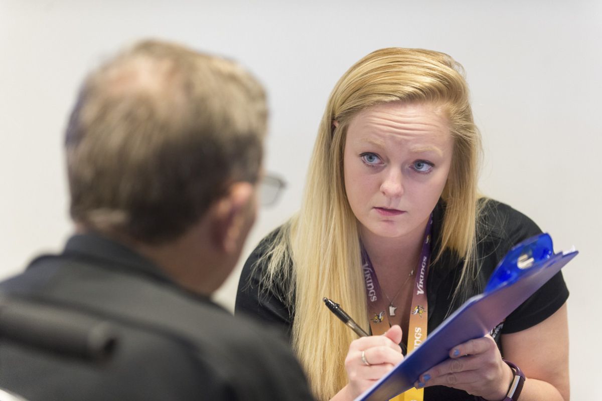 students taking notes on clipboard with patient