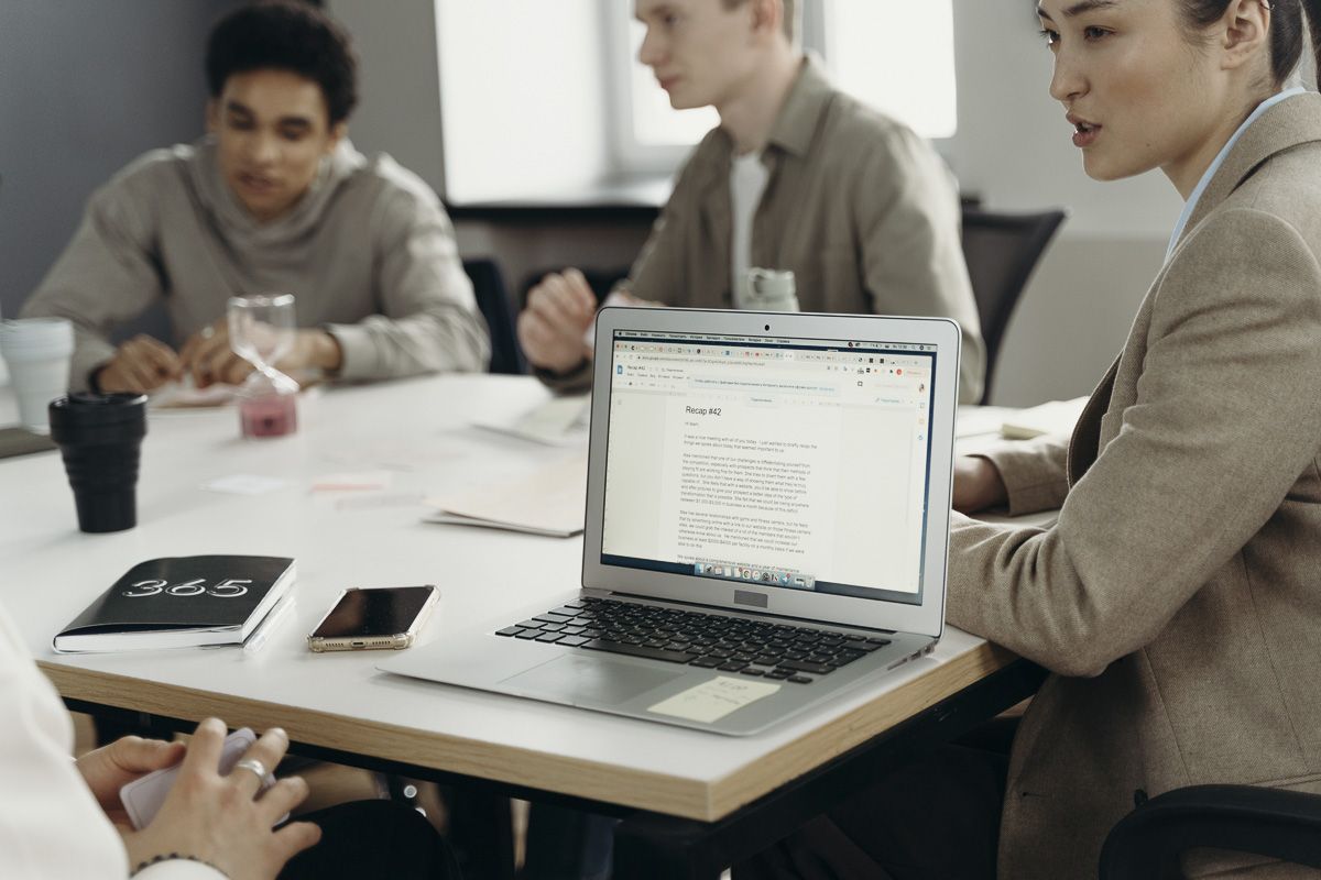 laptop sitting on table in meeting