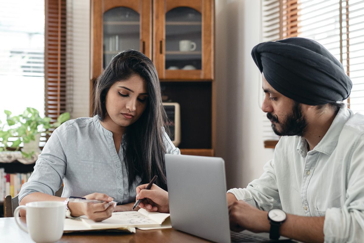 man and woman sitting at table reviewing papers