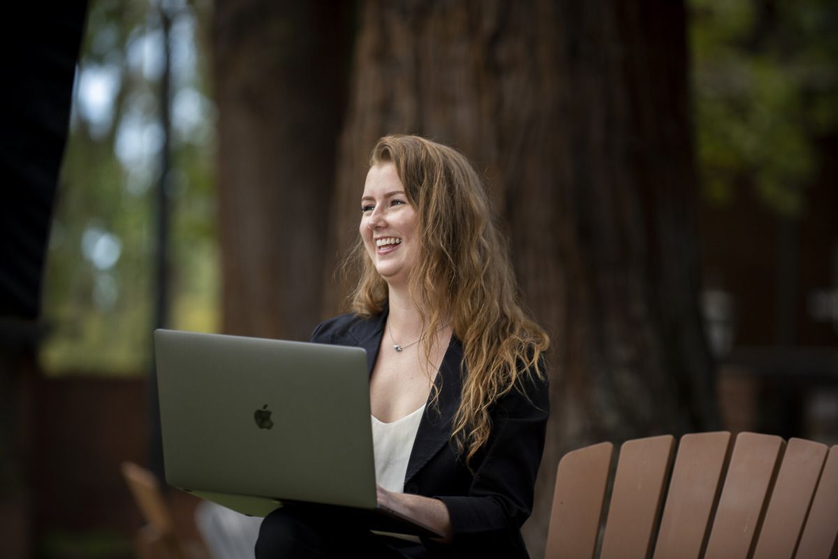 woman using laptop and smiling