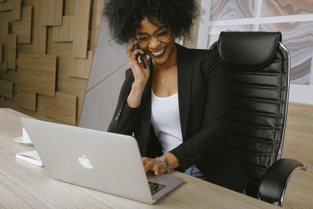 woman using laptop and cell phone