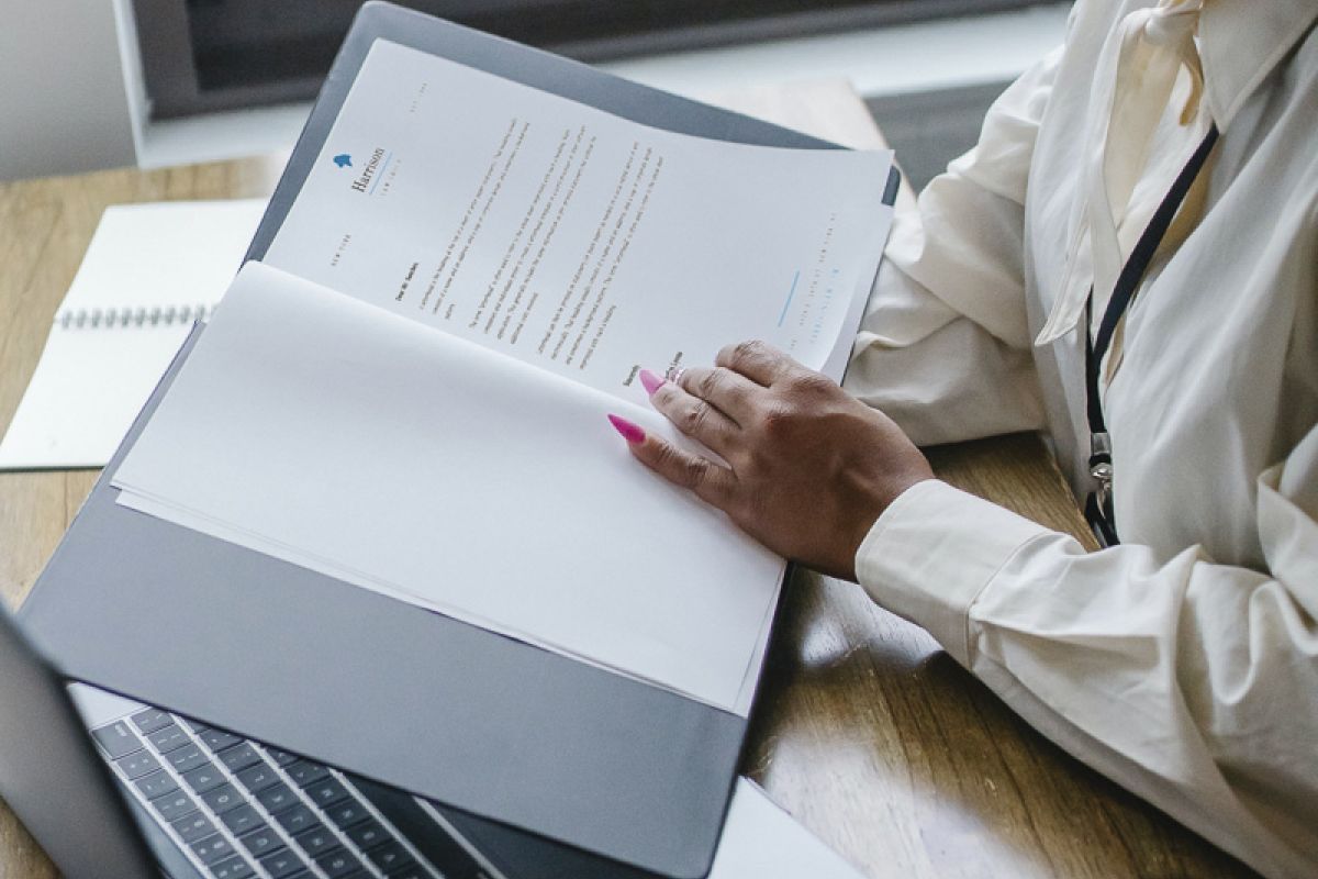 Woman looking at paperwork at desk