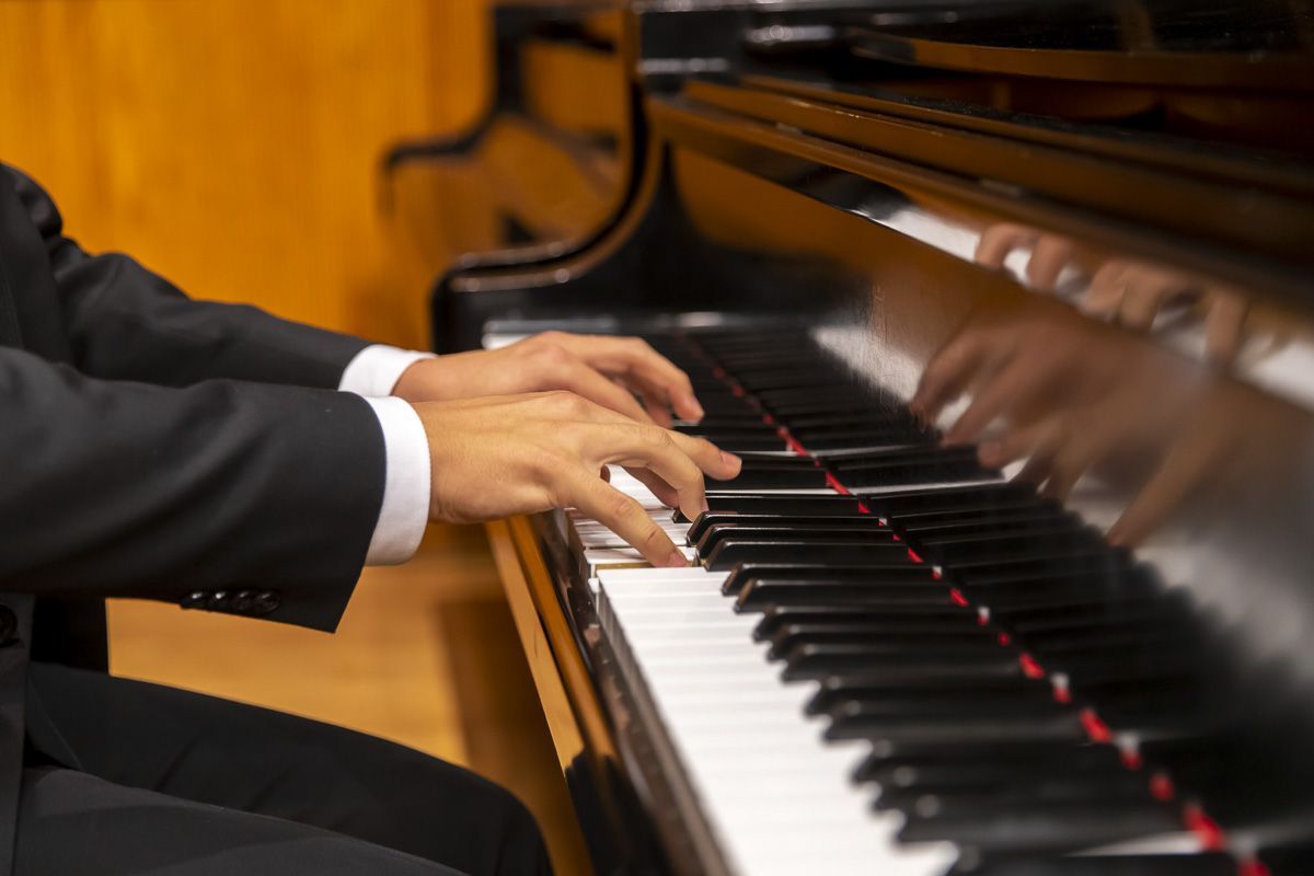 Pianists hands on a keyboard