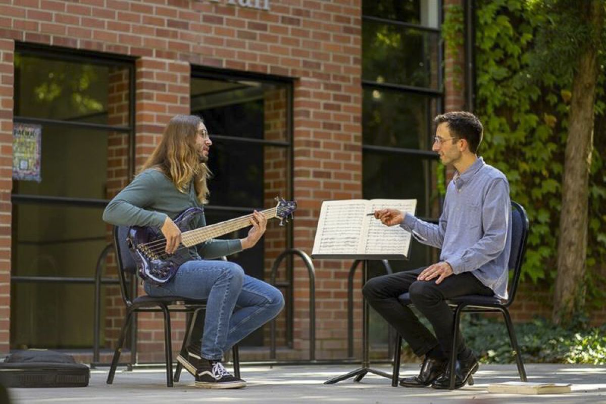 a guitar lesson takes place outside