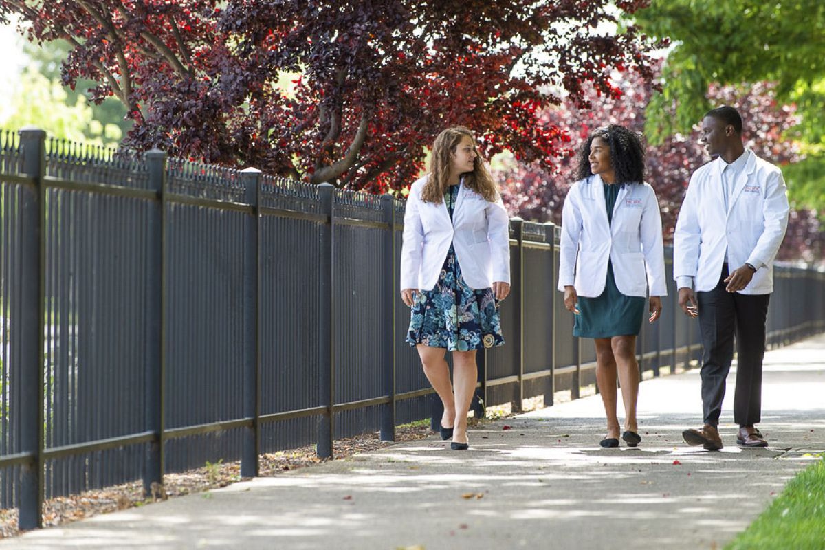 Health Sciences students in white coats on University of the Pacific's campus in Stockton, California.