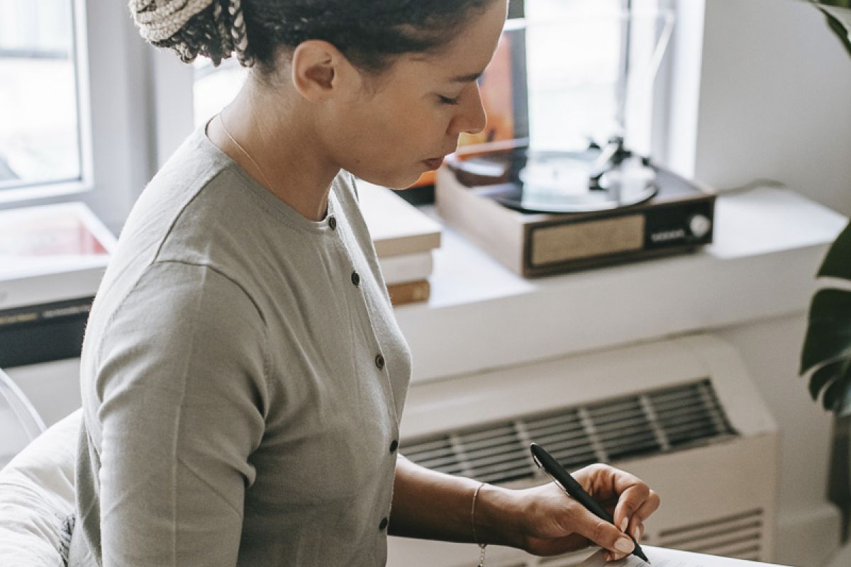 Woman writing on clipboard