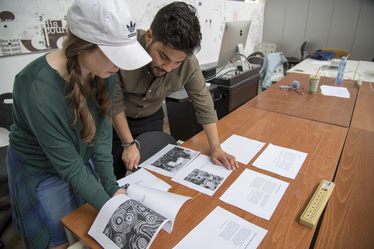 students looking at drafts of papers and essays