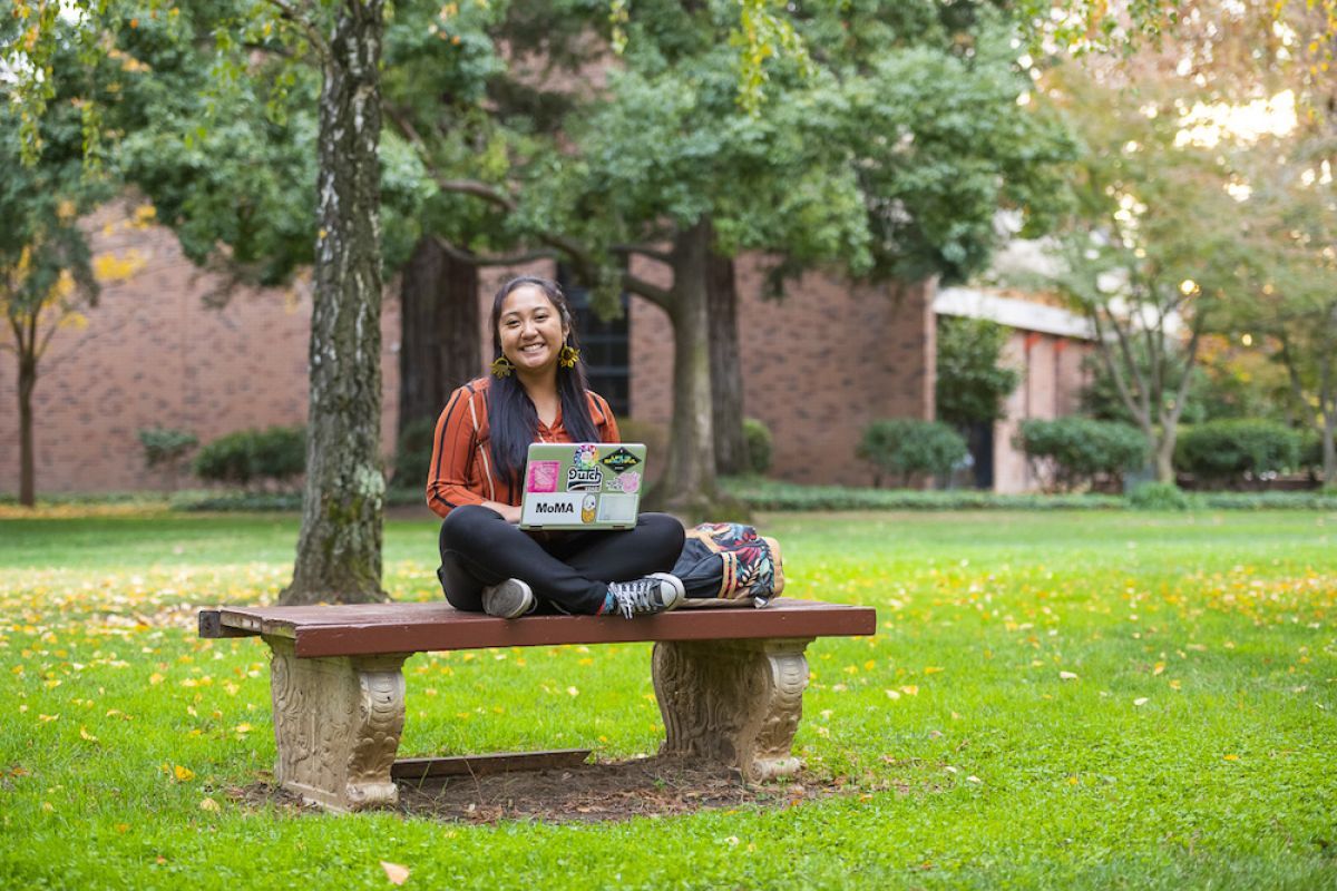 student in middle of campus