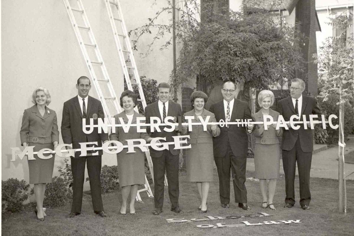 a historic photo of adults holding a 'University of the Pacific McGeorge' sign