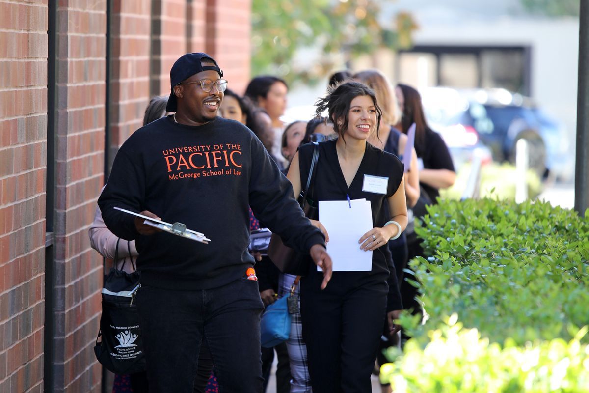 A group of students walk on campus