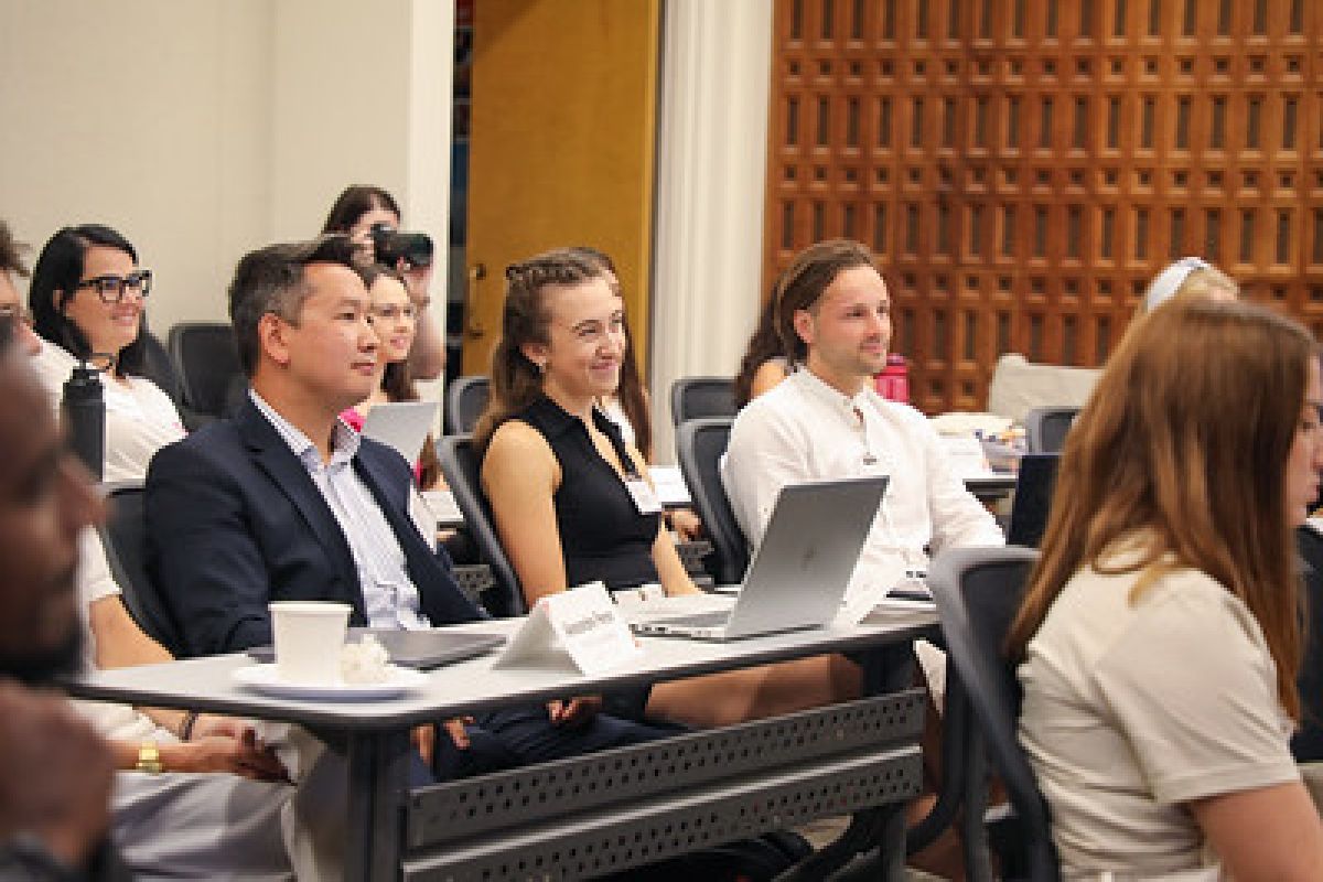 students in a classroom, listening to a presentation