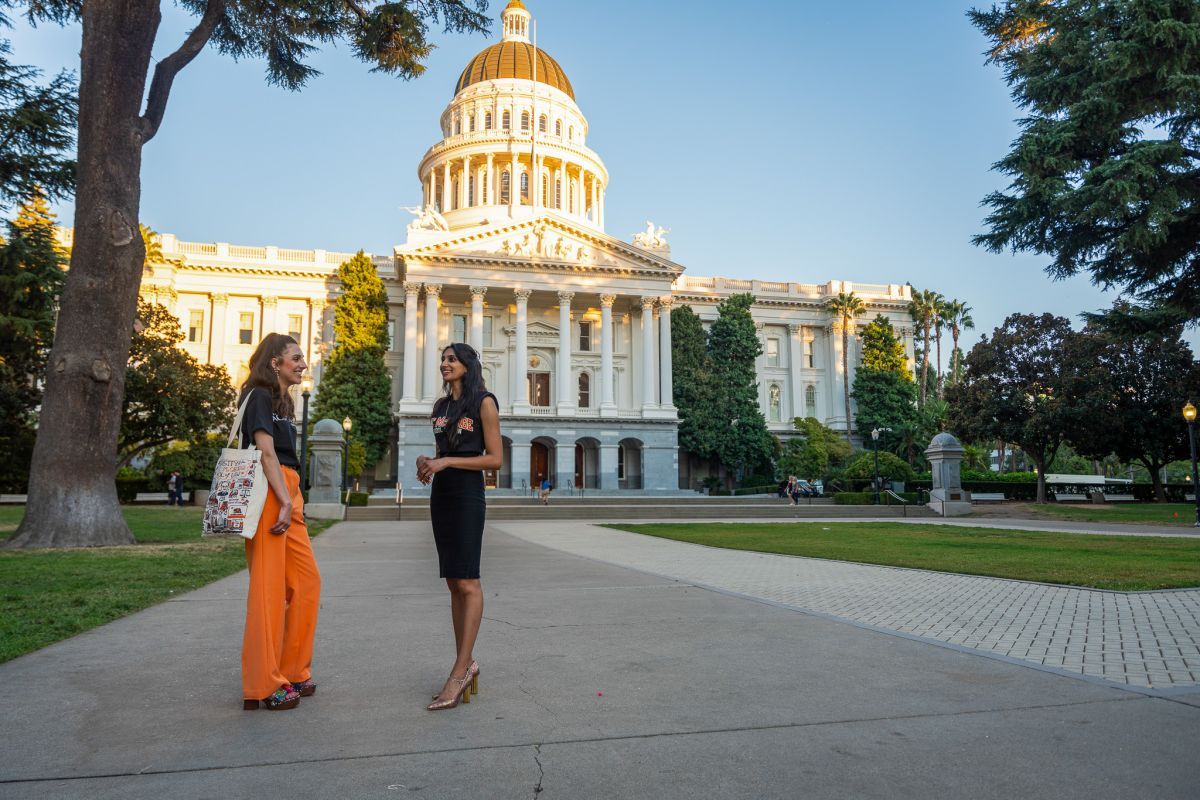 two law students standing in front of the California Capitol