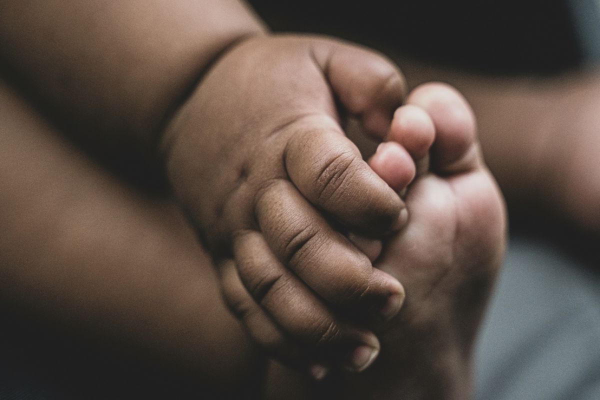a baby's hand and foot