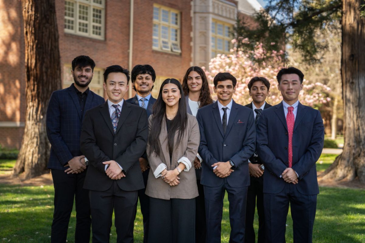 Pacific business students stand together outside a building
