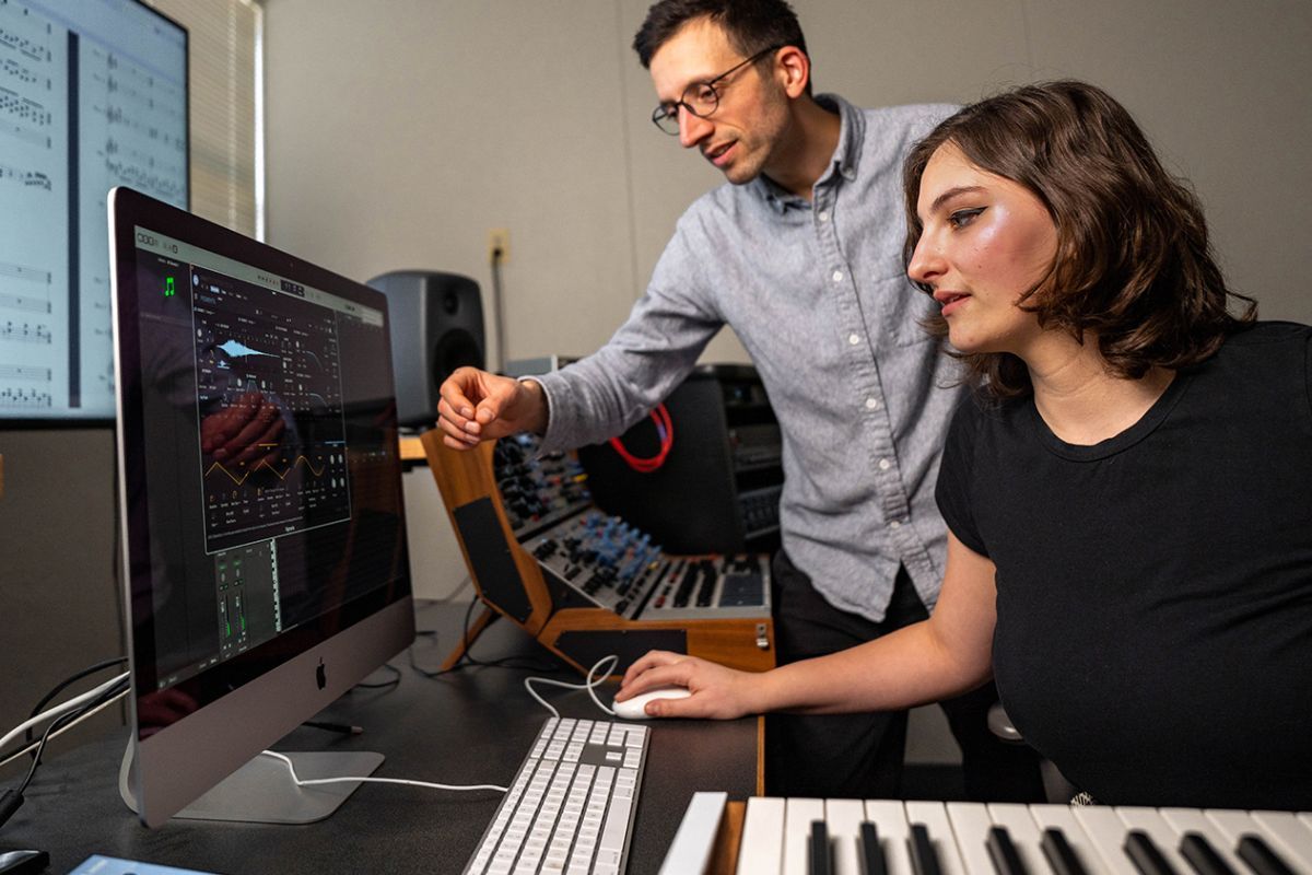 Composition student and her professor in a music studio