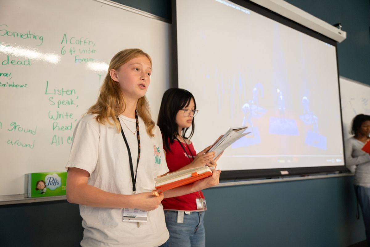 students looking at drafts of papers and essays