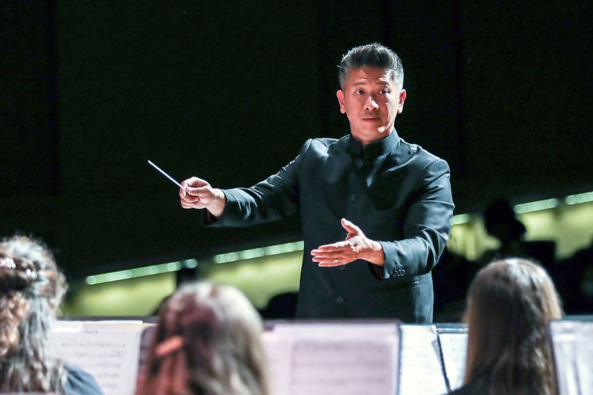 Professor Vu Nguyen conducts a university concert band