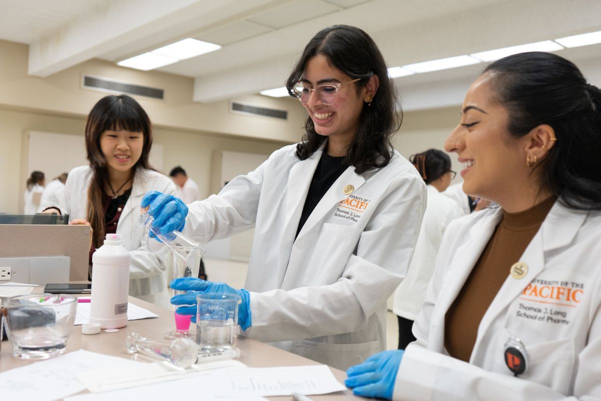 Three pharmacy student working in the compounding lab