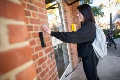 Girl swiping her card for dorm access