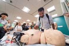 students standing around a manikin